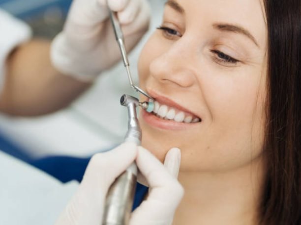 Overview of dental caries prevention. Girl at the dentist chair during a dental scaling procedure. Healthy Smile.